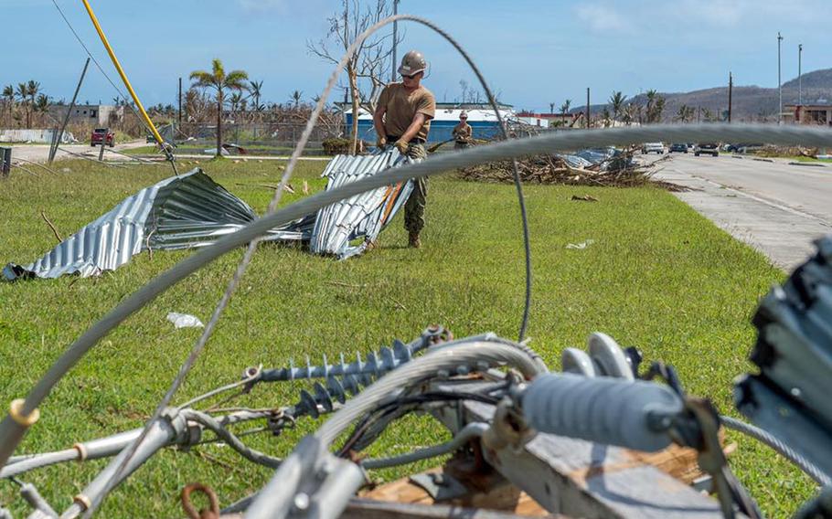 A sailor assigned to the U.S. Navy's Naval Mobile Construction Battalion 1 removes debris from a road on Tinian Island during recovery operations Nov. 1, 2018, following Super Typhoon Yutu. 