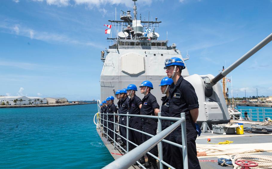 Sailors assigned to the guided-missile cruiser USS Antietam stand in an honor line during a sea and anchor detail in Guam on March 3, 2018. 