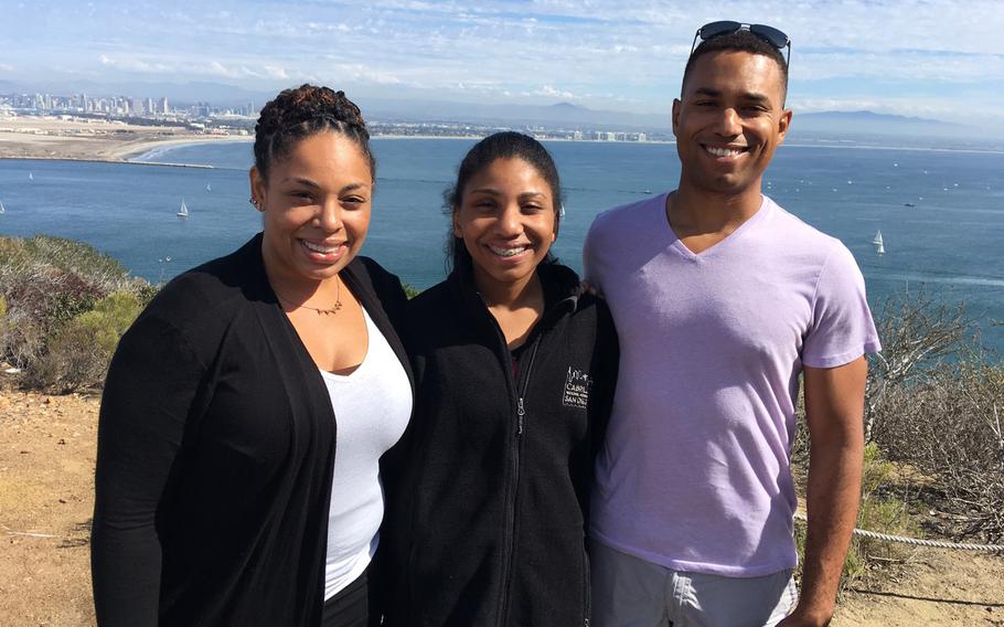 Capt. Jahmar Resilard with his niece Anaiyah Williams, center, and older sister Janine Horne, left.