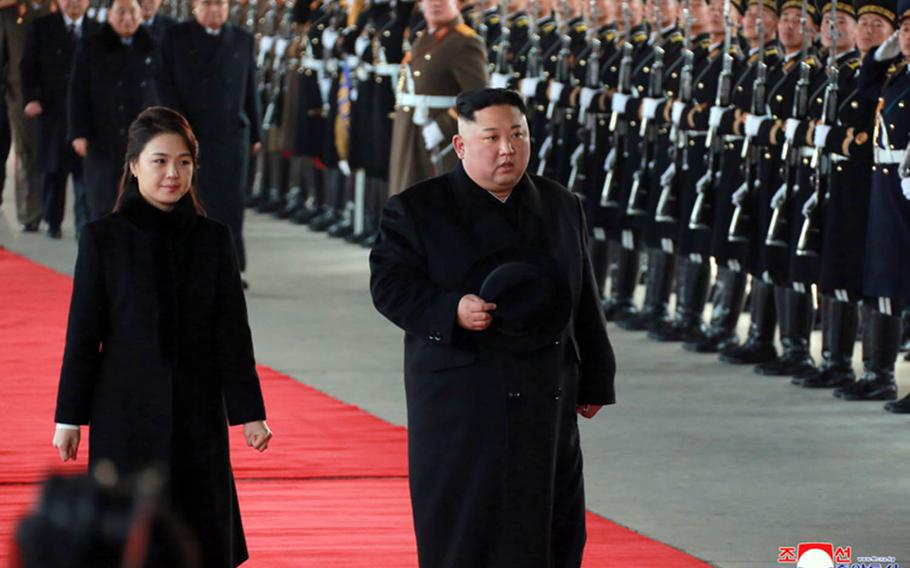In this image from the Korean Central News Agency, North Korean leader Kim Jong Un and his wife, Ri Sol Ju, walk in Pyongyang before boarding a train to China, Monday, Jan. 7, 2019. 
