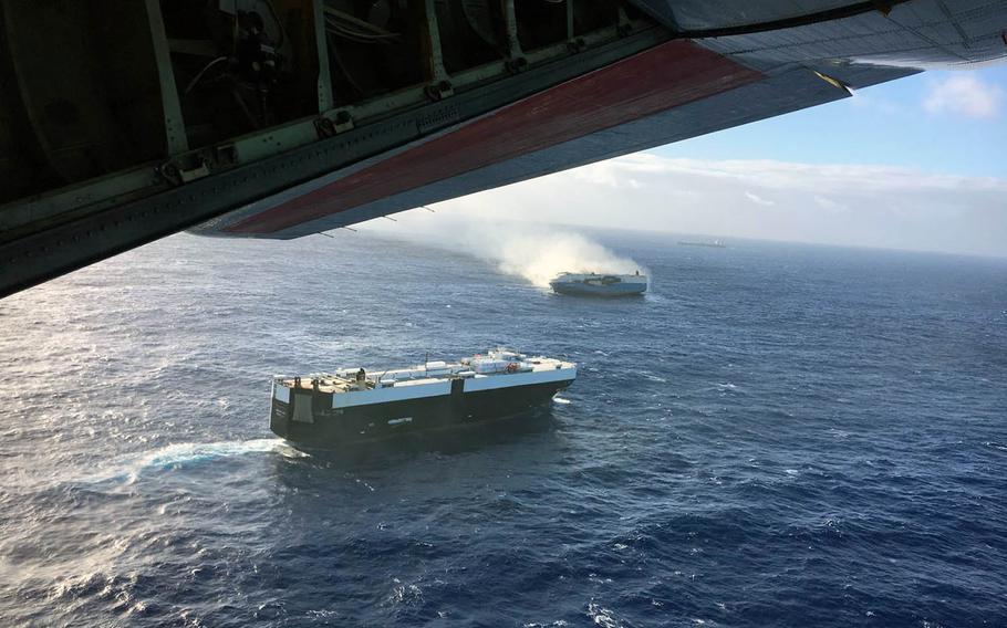 A Coast Guard C-130 flies over the 650-foot Sincerity Ace on fire 1,800 nautical miles northwest of Oahu in the Pacific Ocean, Dec. 31, 2018, and drops supplies to the bulk carrier Genco Augustus also responding to the emergency.