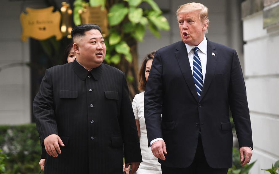 U.S. President Donald Trump walks with North Korea's leader Kim Jong Un during a break in talks at the Sofitel Legend Metropole hotel in Hanoi on Feb. 28, 2019.