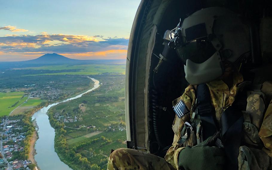 Army Sgt. Kevin Sanchez studies terrain aboard a UH-60 Black Hawk during the Balikatan exercise near Mount Pinatubo in Fort Magsaysay, Philippines, April 1, 2019. 
