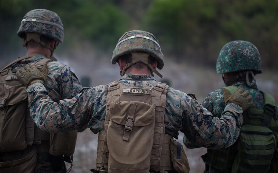 Marine Cpl. David Garduno, center, a rifleman with India Company, 3rd Battalion, 6th Marine Regiment, guides U.S. and Philippine marines during a live-fire drill at Colonel Ernesto Ravina Air Base, Philippines, April 6, 2019.