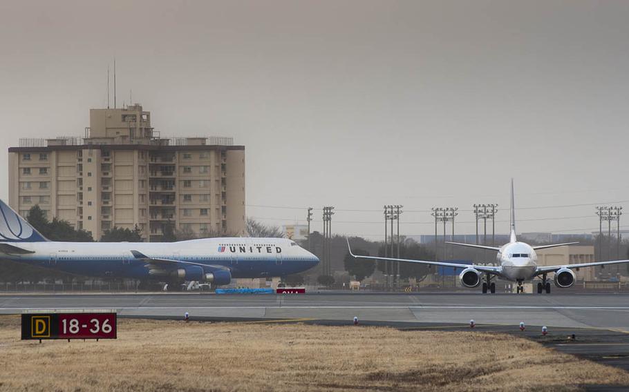 Commercial aircraft arrive at Yokota Air Base in western Tokyo after being diverted from Narita International Airport following a major earthquake and tsunami on March 11, 2011.
