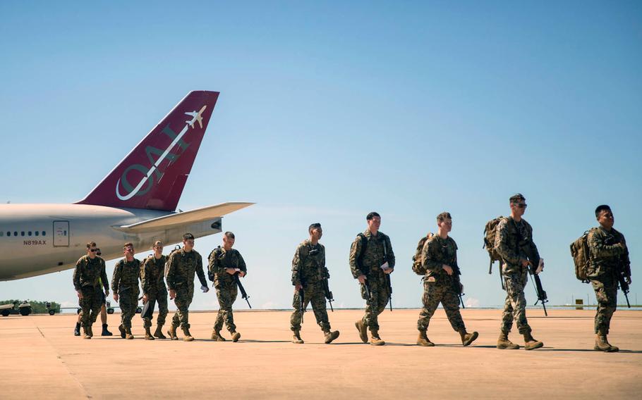 U.S. Marines of Marine Rotational Force Darwin exit a Boeing 777 at the Royal Australian Air Force base at Darwin, Australia, on April 12, 2019.