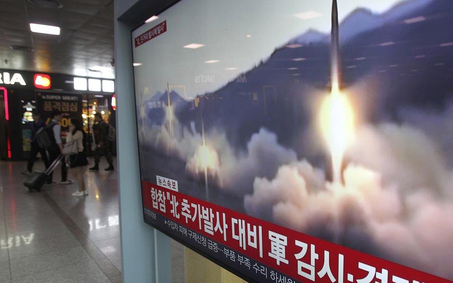 A TV screen shows a file footage of North Korea's missile launch during a news program at the Seoul Railway Station in Seoul, South Korea, Saturday, May 4, 2019. The signs read: "Strengthening military alertness."