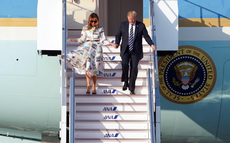 President Donald Trump exits Air Force One with first lady Melania Trump after landing at Haneda International Airport in Tokyo, Saturday, May 25, 2019. 