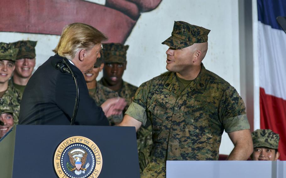 President Donald Trump greets Marine Staff Sgt. Daniel Patterson aboard the USS Wasp at Yokosuka Naval Base, Japan, Tuesday, May 28, 2019. 