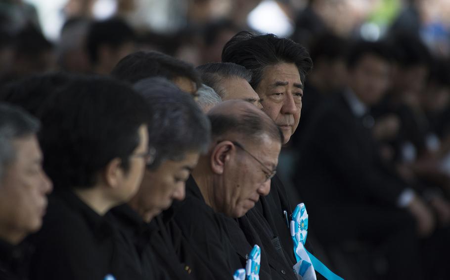 Prime Minister Shinzo Abe, far right, attends the Irei no Hi ceremony at Okinawa Peace Memorial Park, Sunday, June 23, 2019. 