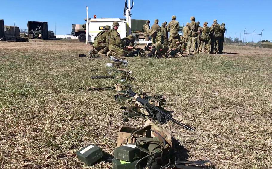 Royal Australian Army soldiers taking part in the Talisman Sabre exercise sort their gear before packing their tactical vehicles for a trip to Shoalwater Bay Training Area, Sunday, July 14, 2019. 