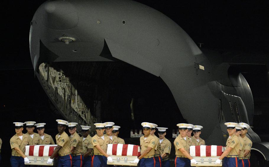 Marine Corps pallbearers transfer the remains of servicemembers from a C-17 cargo jet to a hangar at Joint Base Pearl Harbor-Hickam, Hawaii, Wednesday, July 17, 2019. The identified remains are Marines or sailors killed during the Battle of Tarawa in 1943. 