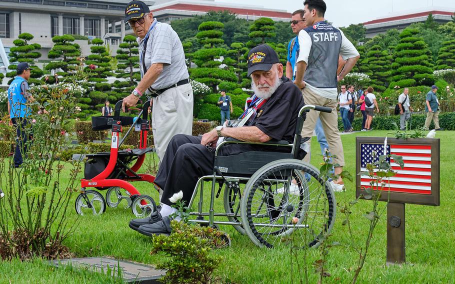 Korean War veterans read the headstones of U.S. servicemembers during a visit to the United Nations Memorial Cemetery in Busan, South Korea, Thursday, July 25, 2019.
