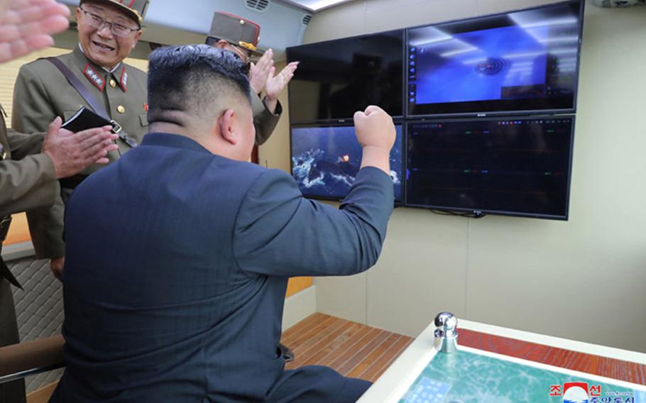 This undated photo, released by the state-run Korean Central News Agency on Aug. 17, 2019, shows North Korean leader Kim Jong Un observing the test-firing of a ‘new weapon,’ according to KCNA.
