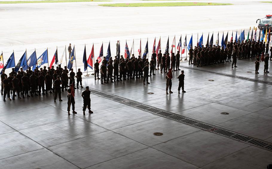 Marines stand in formation as  Col. Frederick L. Lewis Jr. assumes command at Marine Corps Air Station Iwakuni, Japan, from Col. Richard F. Fuerst on Thursday, Aug. 22, 2019.