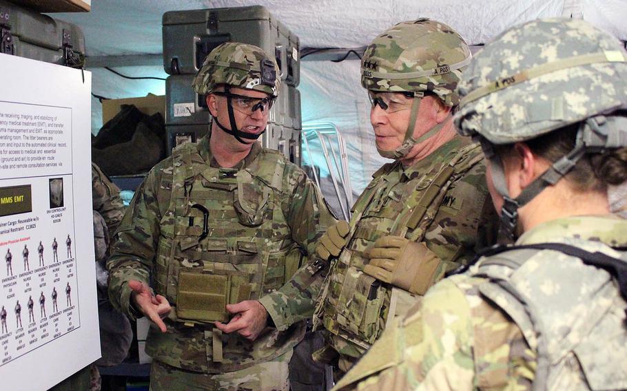 Col. Andrew Landers, M.D., left, briefs Lt. Gen. Michael Bills, Eighth Army commander, on the field hospital conversion concept at Rodriquez Range, South Korea, in March 2019.