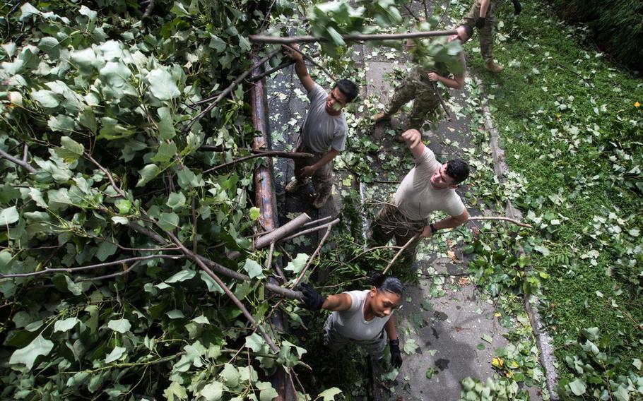 Airmen clean up debris from Typhoon Faxai at Yokota Air Base, Japan, Monday, Sept. 9, 2019. 