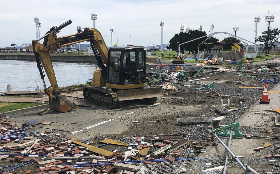 Workers clear debris from Typhoon Faxai at Yokosuka Naval Base, Japan, Monday. Sept. 9, 2019. 