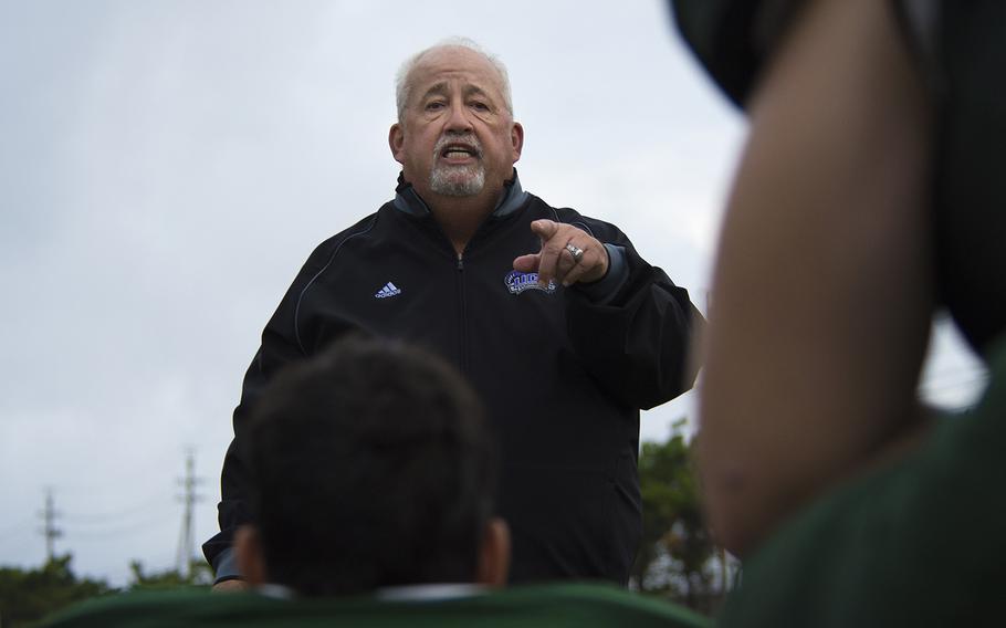 A coach from the Kubasaki Dragons speaks to players during the first football game of the season against the Kadena Panthers at Mike Petty Stadium on Camp Foster, Okinawa, Japan, Saturday, Sept. 7, 2019. 