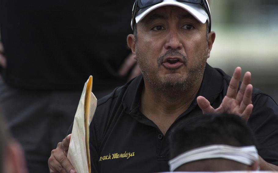 A coach from the Kadena Panthers speaks to players during the first football game of the season against and the Kubasaki Dragons at Mike Petty Stadium on Camp Foster, Okinawa, Japan, Saturday, Sept. 7, 2019. 