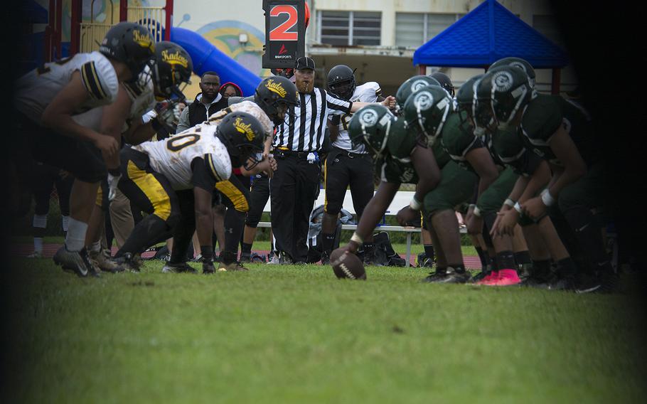 Players from the Kubasaki Dragons prepare to hike the ball during the first football game of the season against the Kadena Panthers at Mike Petty Stadium on Camp Foster, Okinawa, Japan, Saturday, Sept. 7, 2019. 