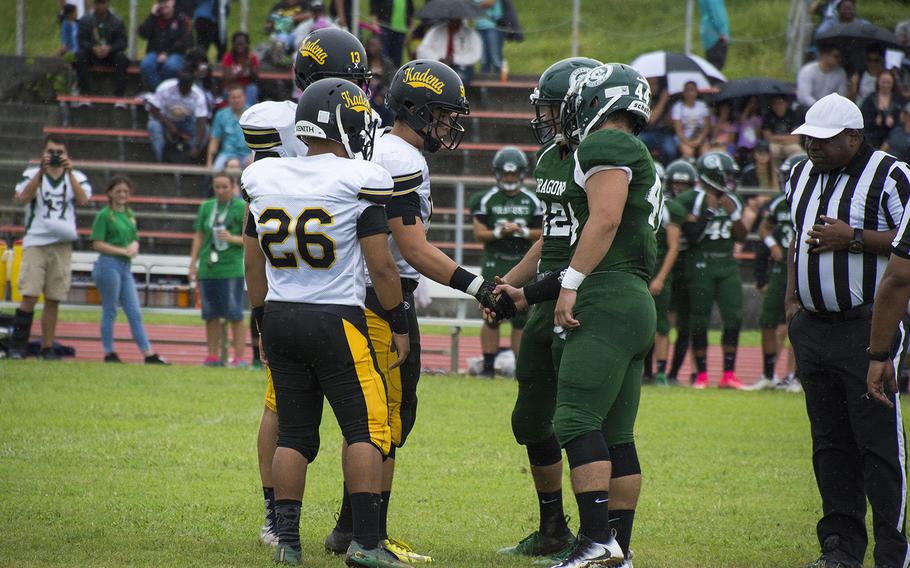 Players from the Kadena Panthers and the Kubasaki Dragons shake hands before the start of the first football game of the season at Mike Petty Stadium on Camp Foster, Okinawa, Japan, Saturday, Sept. 7, 2019. 