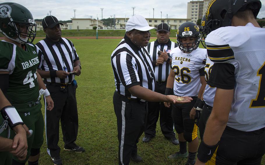 A referee flips a coin before the start of the first football game of the season between the Kadena Panthers and the Kubasaki Dragons at Mike Petty Stadium on Camp Foster, Okinawa, Japan, Saturday, Sept. 7, 2019. 