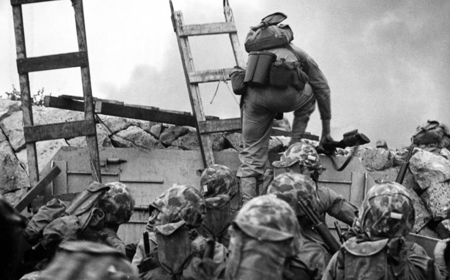 First Lt. Baldomero Lopez leads Marines over a seawall during the Incheon landing on Sept. 15, 1950. 