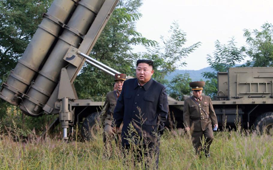North Korean leader Kim Jong Un stands near a mobile launcher in this photo released by the Central Korean News Agency on Wednesday, Sept. 11, 2019.
