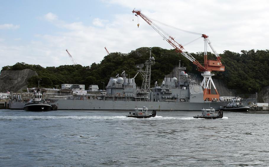 Harbor tugs help secure the guided-missile cruiser USS Shiloh at Yokosuka Naval Base, Japan, as the installation prepares for Typhoon Hagibis, Thursday, Oct. 10, 2019. 
