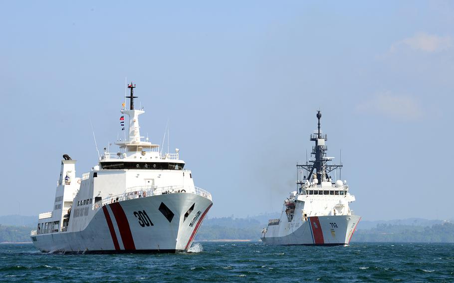 The Coast Guard cutter Stratton, right, sails alongside an Indonesian coast guard vessel in the Singapore Strait, Aug. 11, 2019. 