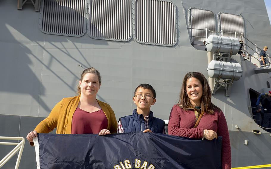 From left to right, Christina Ellison and Mason and Jamie Peevy were on hand to watch their loved ones, Petty Officer 1st Class Robert Peevy and Petty Officer 2nd Class Zephrim Ellison, depart Yokosuka Naval Base, Japan, aboard the USS John S. McCain, Monday, Oct. 28, 2019. 