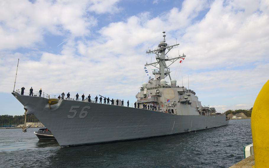 The USS John S. McCain departs Yokosuka Naval Base, Japan, Monday, Oct. 28, 2019, for the first time since suffering significant damage in a fatal collision more than two years ago.