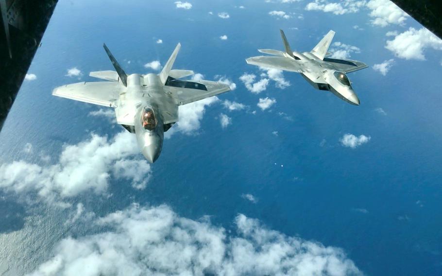 A pair of Air Force F-22 Raptors fly above the Coral Sea during the Talisman Sabre exercise, July 19, 2019.