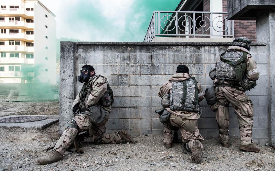 Soldiers from the 1st Armored Brigade Combat Team, 1st Infantry Division don protective masks during training at Rodriguez Live Fire Range in Paju, South Korea, Tuesday, March 21, 2017.