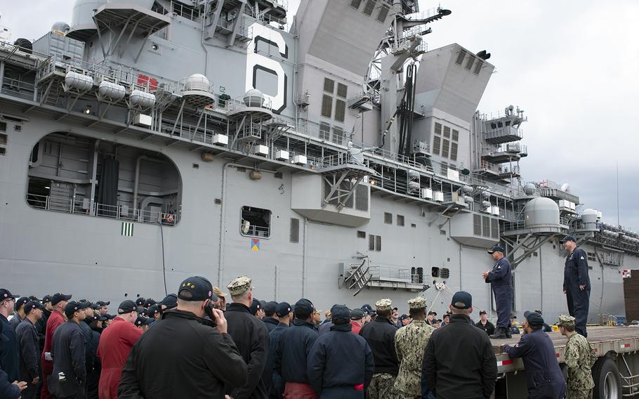 An officer assigned to the amphibious assault ship USS America speaks to sailors after arriving at Sasebo Naval Base, Japan, Friday, Dec. 6, 2019.
