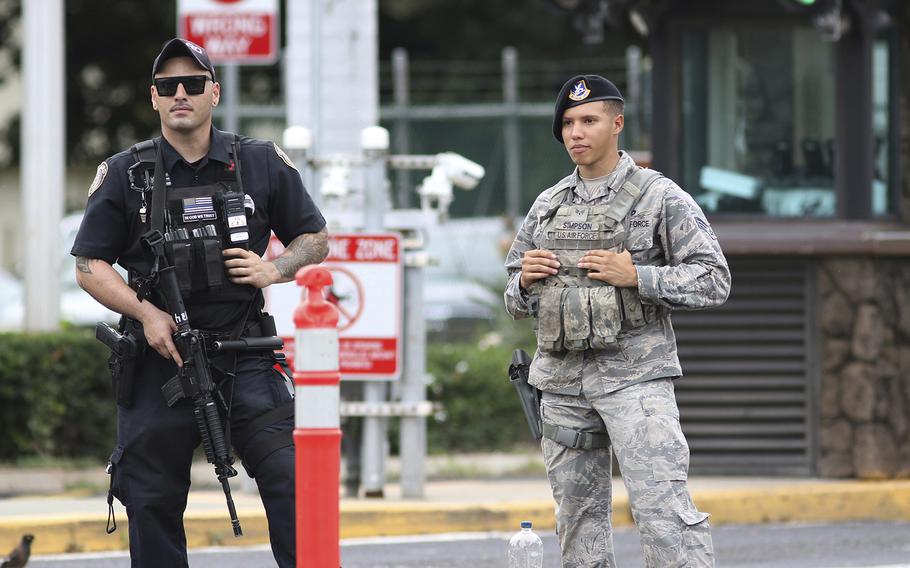 Security stands guard outside the main gate at Joint Base Pearl Harbor-Hickam, in Hawaii, Wednesday, Dec. 4, 2019.