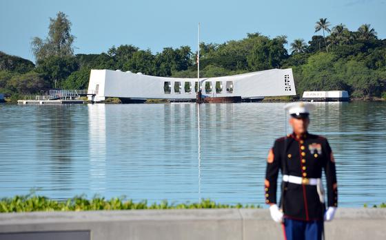 A Marine stands with his back to the USS Arizona Memorial during a rifle salute Dec. 7, 2019, at the Pearl Harbor National Memorial that was part of a ceremony marking the 78th anniversary of the Japanese surprise attack on Oahu.