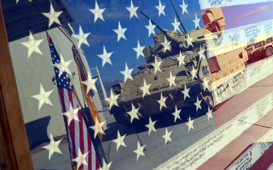 A U.S. flag that survived for more than a decade after it was hidden from insurgents in Iraq is displayed during a ceremony at Fort Bliss, Texas, Sept. 11, 2019. 
