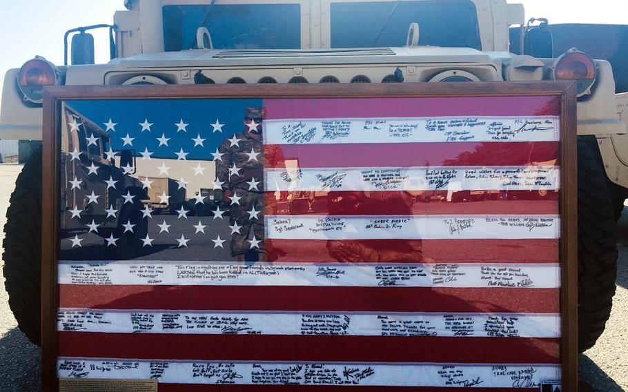 A U.S. flag that survived for more than a decade after it was hidden from insurgents in Iraq is displayed during a ceremony at Fort Bliss, Texas, Sept. 11, 2019. 
