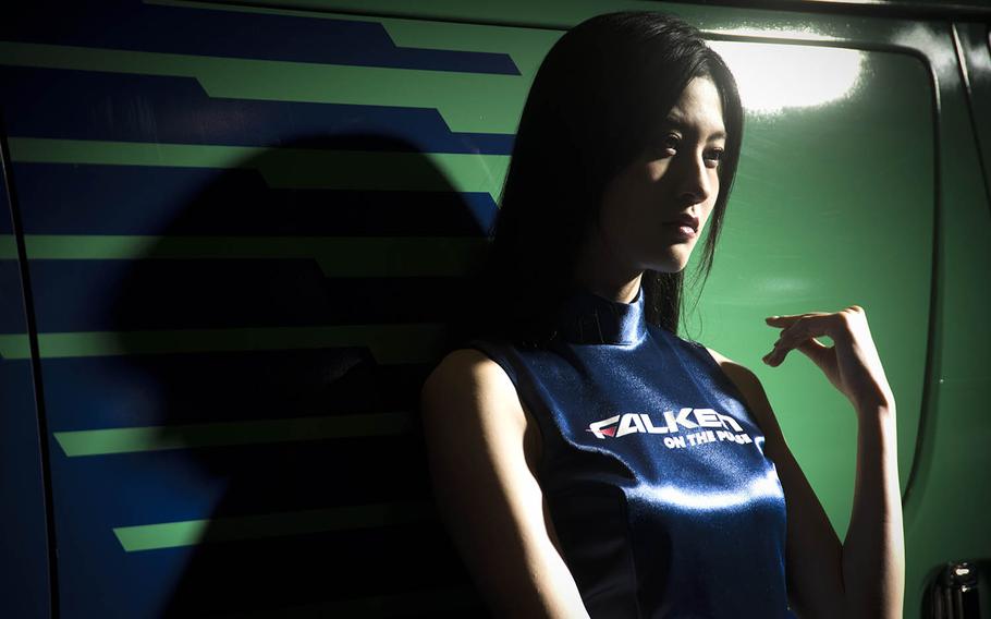 A model working for Falken Tires poses for guests during Tokyo Auto Salon 2020 in Chiba, Japan, Friday, Jan. 10, 2020. 