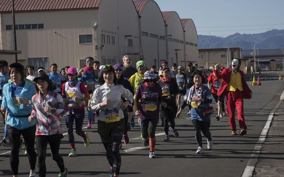 Runners, including one dressed as the Joker, take part in the 39th annual Yokota Striders Frostbite road race at Yokota Air Base, Japan, Sunday, Jan. 19, 2020. 