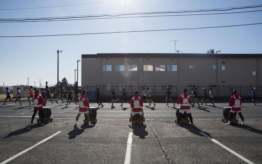 Taiko drummers cheer on runners taking part in the 39th annual Yokota Striders Frostbite road race at Yokota Air Base, Japan, Sunday, Jan. 19, 2020. 