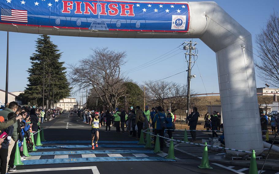 A young athlete crosses the finish line during the 39th annual Yokota Striders Frostbite road race at Yokota Air Base, Japan, Sunday, Jan. 19, 2020. 