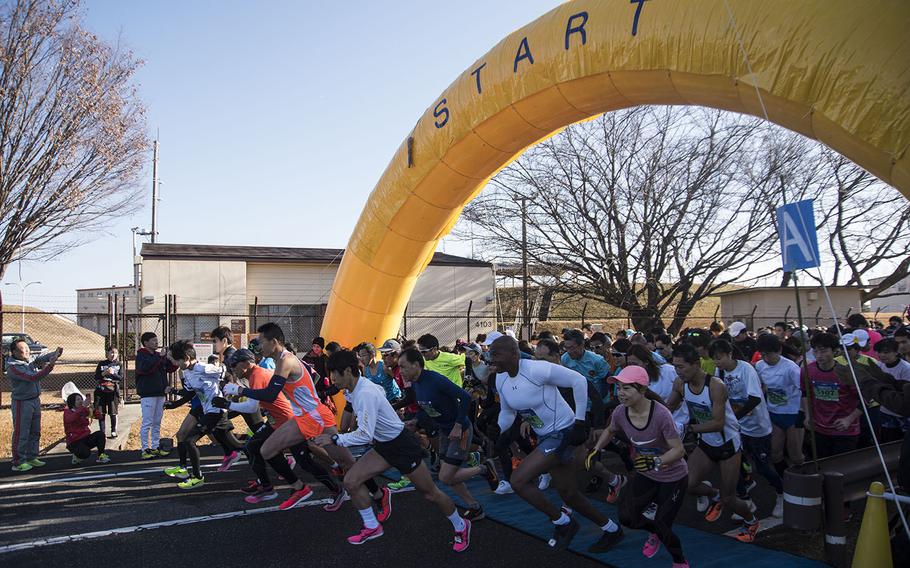 Runners take off from the starting line of the 39th annual Yokota Striders Frostbite road race at Yokota Air Base, Japan, Sunday, Jan. 19, 2020.