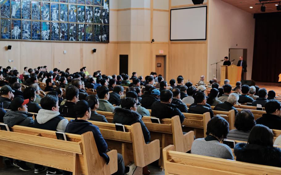 Hundreds of people pack Four Chaplains Memorial Chapel at Camp Humphreys, South Korea, for a town hall meeting about a possible furlough for South Korean base workers, Wednesday, Jan. 29, 2020.