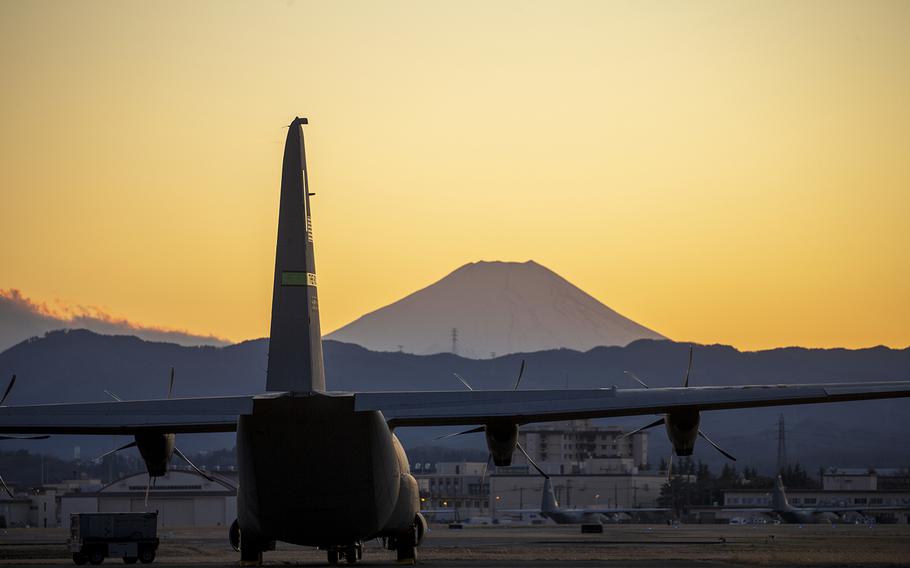 A C-130J Super Hercules sits on the flightline at Yokota Air Base, Japan, with Mount Fuji in the background, Feb. 9, 2020.