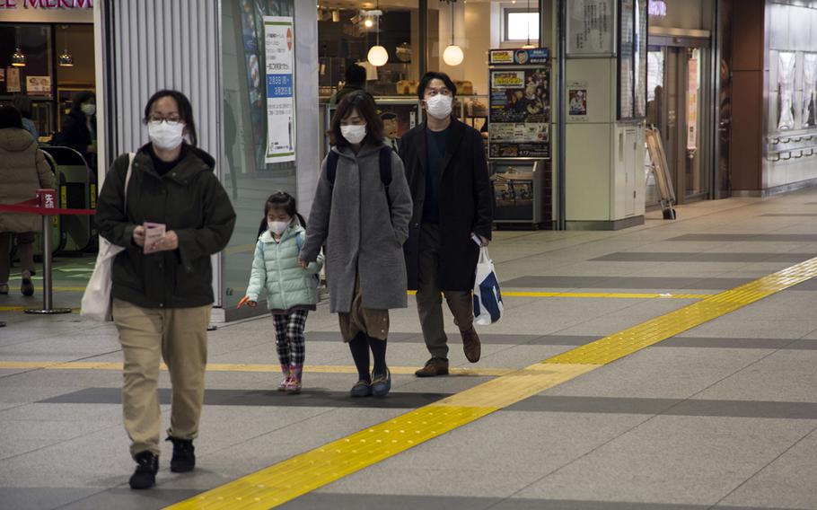 Commuters wear masks inside Haijima Station, near Yokota Air Base, Japan, Wednesday, Feb. 26, 2020. 