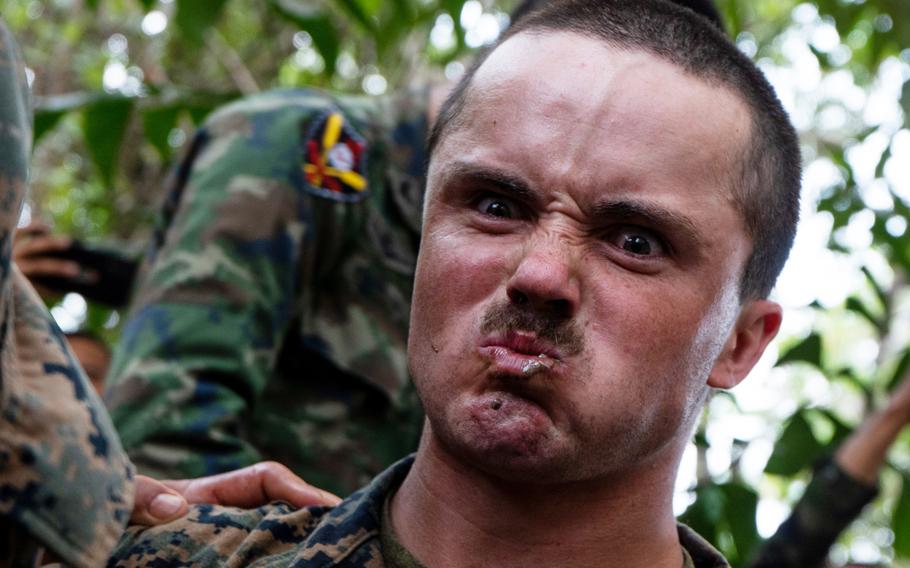 A Marine with 1st Battalion, 5th Marine Regiment, eats a live scorpion as part of jungle survival training during exercise Cobra Gold 2020 at Ban Chan Khrem, Chanthaburi, Thailand, March 1, 2020. 