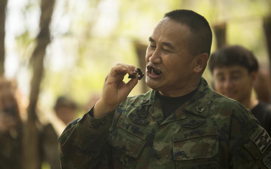 Royal Thai Marine Chief Petty Officer 1st Class Pairoj Prasarnsai eats an insect as part of jungle survival training with U.S. Marines from Alpha Company, Battalion Landing Team, 1st Battalion, 5th Marine Regiment, during exercise Cobra Gold 2020 at Ban Chan Khrem, Chanthaburi, Thailand, March 2, 2020. 